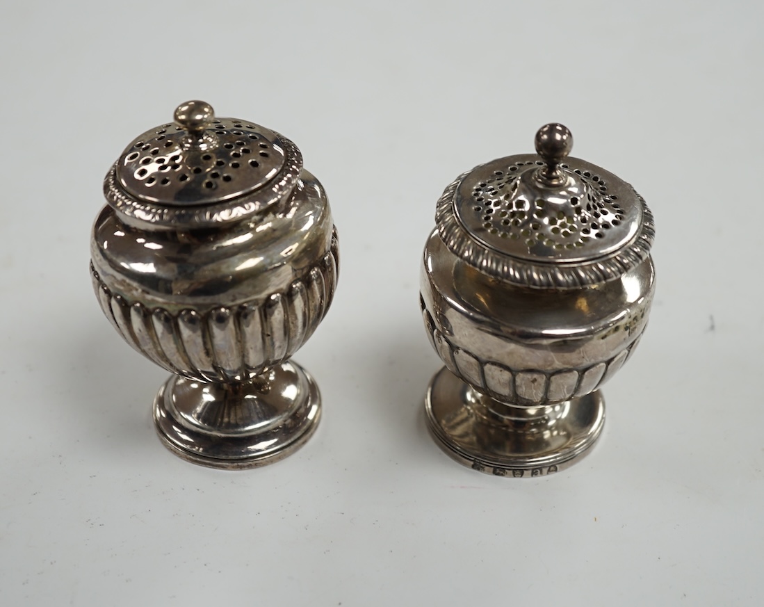 A George III silver pedestal pepper pot, by Eames & Barnard, London, 1816, 75mm and one other similar pepper pot, marks rubbed. Condition - poor